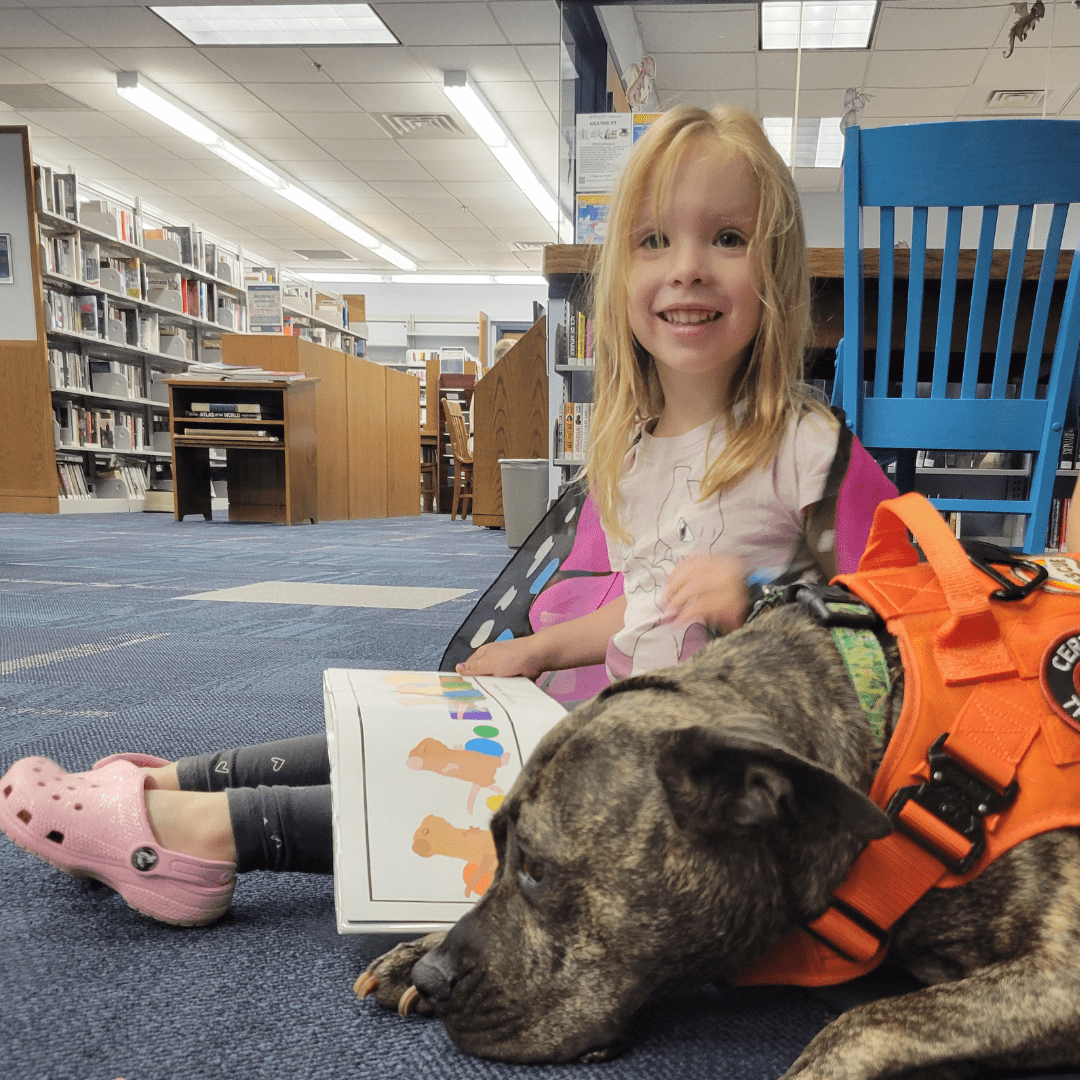 Leona the certified therapy dog loves to read with library patrons.